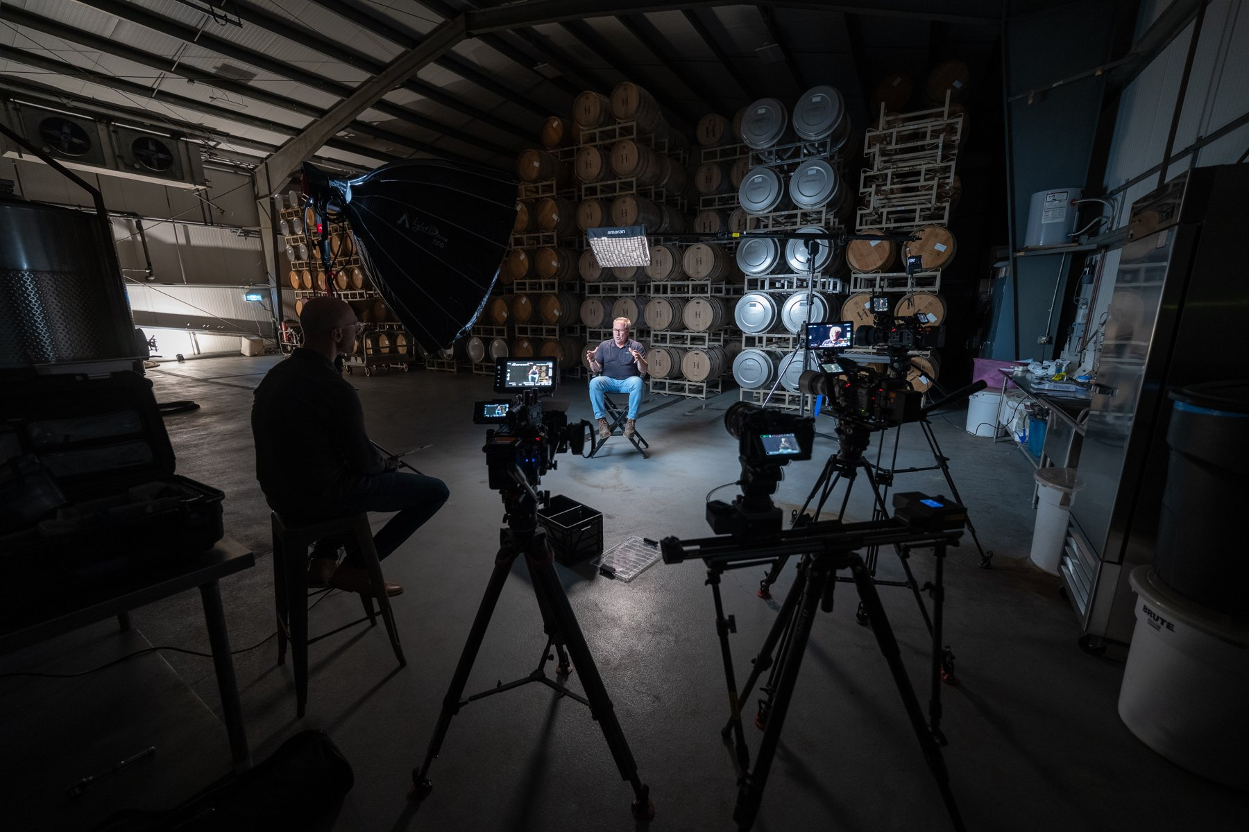Four-camera interview setup in a barrel room, with a slider and interview lighting